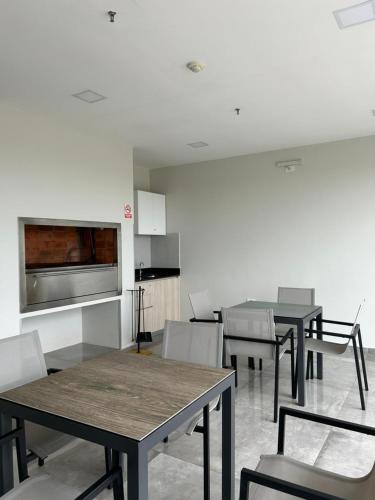 una sala da pranzo con tavoli e sedie e una cucina di Home Herrera ad Asunción