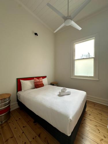 a bedroom with a large bed with a ceiling fan at ARK Apartments in Echuca
