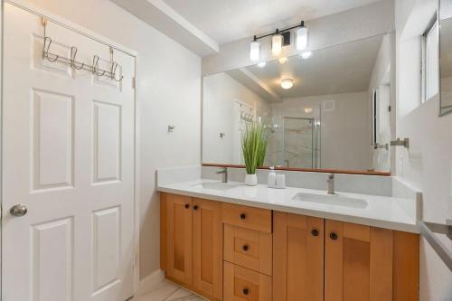 a bathroom with a sink and a mirror at Casita Full Kitchen-AC-Ping Pong in Escondido