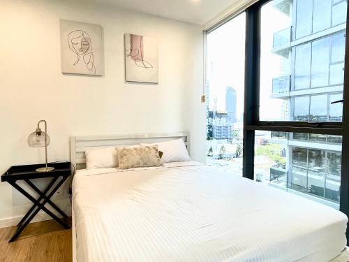 a bedroom with a bed and a large window at Minimalist Studio Escape 31506-2 in Brisbane