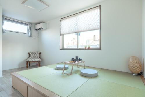 a living room with a table and a chair at Skytree House Oshiage New 3-story Villa, 2 Showers, 2 Toilets, 4 Rooms, 3 min walk to Oshiage Station in Tokyo