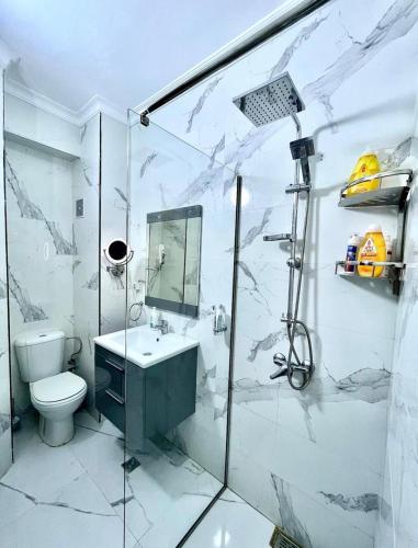 a bathroom with a toilet and a sink and a shower at Seaside 1 min From Beach & Train Station in Tangier