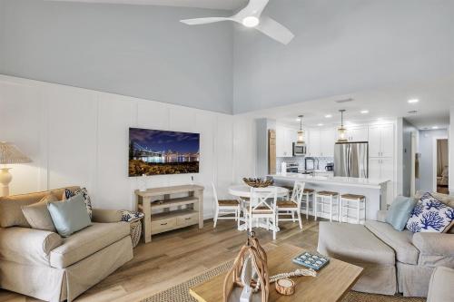 a living room with a couch and a table at Drift Away at The Ocean Gallery in Saint Augustine