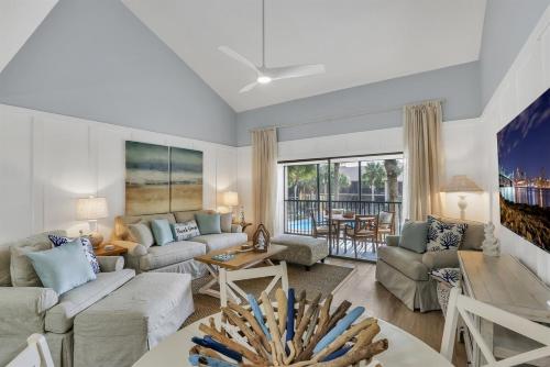 a living room with a couch and a table at Drift Away at The Ocean Gallery in Saint Augustine