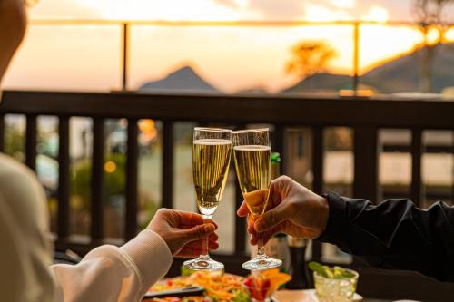 two people are holding champagne glasses on a table at Minamiizu Yuhigaoka Camp Site - Camp - Vacation STAY 42067v in Ihama