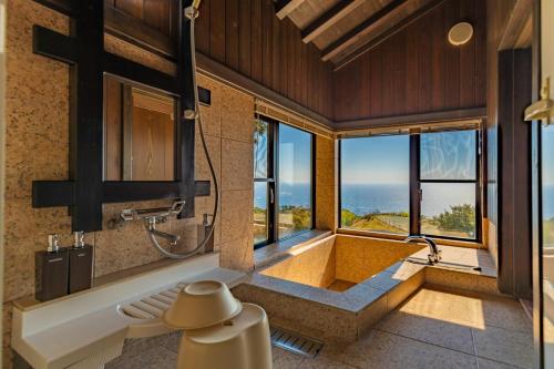 a bathroom with a tub and a shower with windows at Minamiizu Yuhigaoka Camp Site - Camp - Vacation STAY 42067v in Ihama
