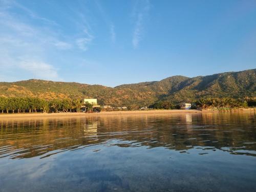a body of water with mountains in the background at The Vista My Hoa in Ninh Hải
