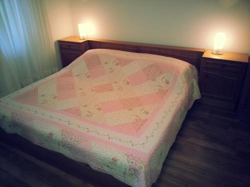 a bedroom with a bed with two lights on it at Studio Apartman Kamelija in Opatija