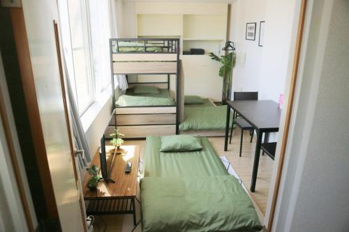 a small room with two bunk beds and a table at Joynas Ise / Vacation STAY 32706 in Ise