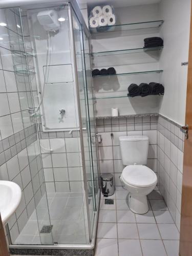 a bathroom with a toilet and a glass shower at Um lar em Brasília, super aconchegante e com ar condicionado in Brasília