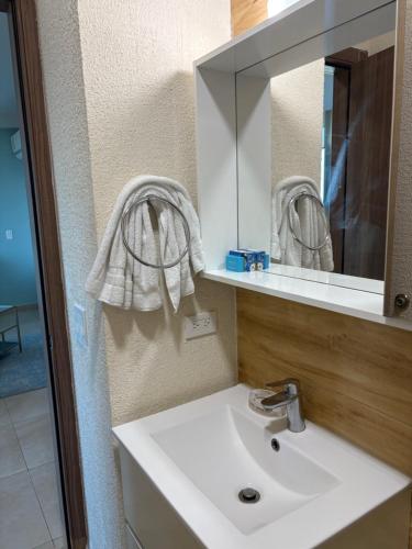 a bathroom with a white sink and a mirror at Gorgona playa in Nueva Gorgona