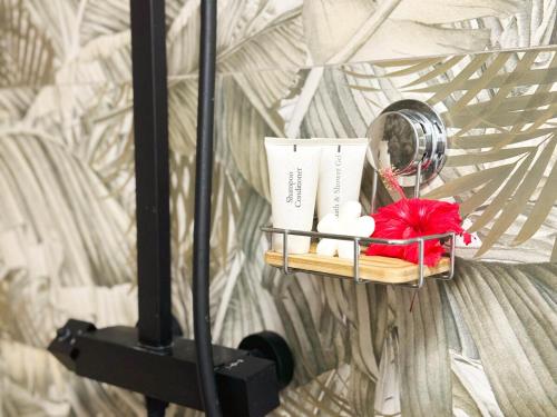 a shelf with towels and a mirror on a wall at Air-conditioned sea access studio, fiber optic, parking in Punaauia