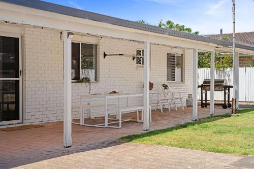 a white patio with a table and chairs at Buddina Bliss - Pet Friendly Holiday Home in Buddina