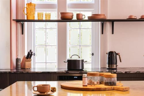 a kitchen with a counter top with a pot on the stove at Miss Midgley's - Refectory in Brisbane