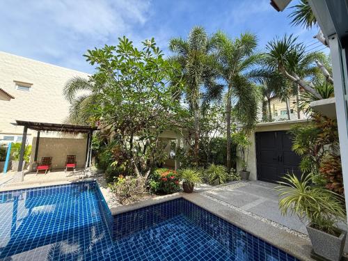 a swimming pool in front of a house at Villa 4 BD Nai Harn Beach by Mill in Ban Saiyuan (1)