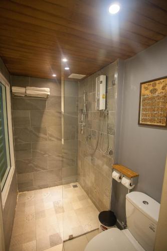 a bathroom with a shower and a toilet at Celosia Chiang Mai Hotel in Chiang Mai
