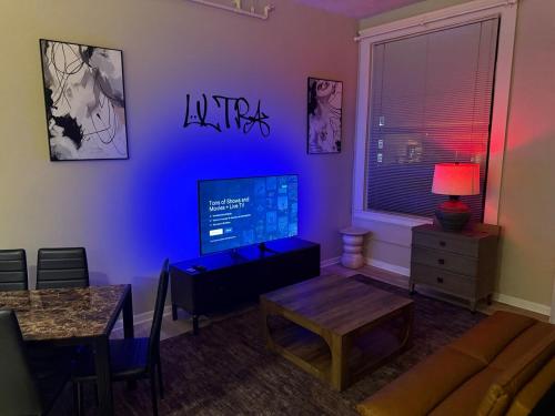 a living room with a couch and a tv at Downtown Loft Free Street Parking Gym w Sauna in Cleveland