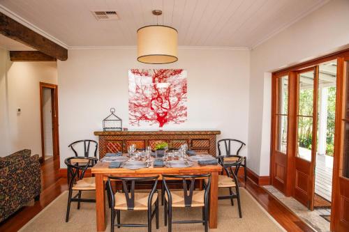 a dining room with a wooden table and chairs at Old Duninald House - Historic Farmhouse Experience in Paterson