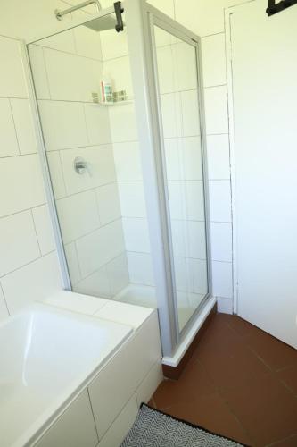a bathroom with a shower and a white tub at Sleep-A-Lot in Piet Retief