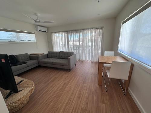 a living room with a couch and a table at Swansea 2 Bedroom Apartment in Swansea