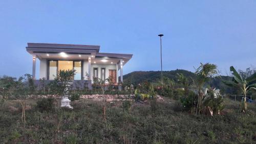 a small house in the middle of a field at Wisuthida Villa in Wang Saphung