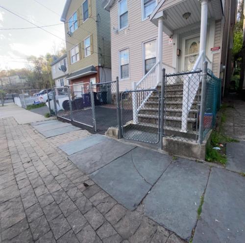 een hek voor een huis met trappen bij Private bathroom inside Master bedroom! in Paterson