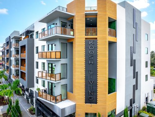 a rendering of a building with a yellow facade at KOOSH - Boutique Aparthotel in Fort Lauderdale