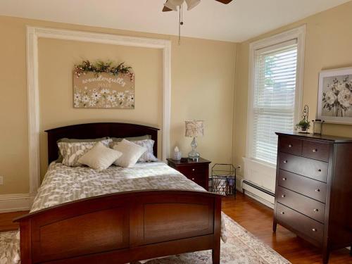 une chambre avec un grand lit et une commode dans l'établissement Beautiful Victorian Apartment, à Bay City