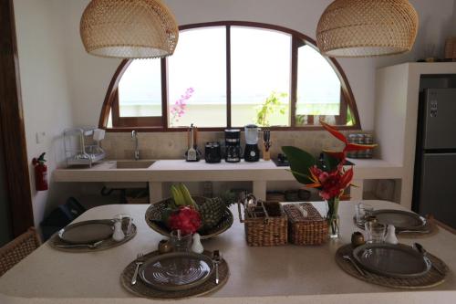 a kitchen with a table with two sinks and a window at Momy Breeze Uluwatu in Bingin Beach