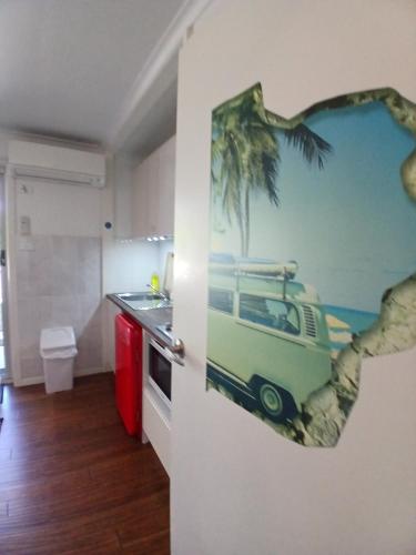a kitchen with a picture of a van on the wall at Marazul BEST DEAL - Stone Bathtub, WIFI, Functional - Mandarins and lemons when available in Vincentia