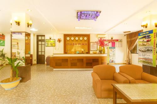 a waiting room with two couches and a counter at Cửa Đại Beach Hotel in Hoi An