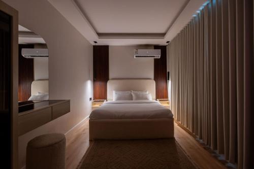 a hotel room with a bed and a window at Ohud Suites - أجنحة أحد in Riyadh
