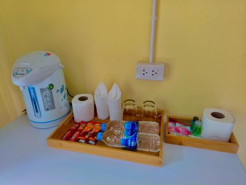 a table with a blender and some food and toilet paper at Ari homestay in Ko Kood