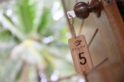 a wooden door tag with the number on it at The TALAY in Ban Na Tai