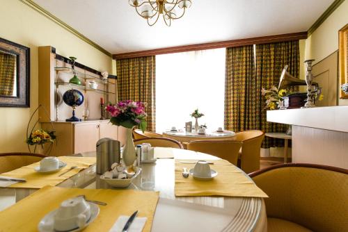 a dining room with a table and chairs at Löwen Hotel in Offenbach