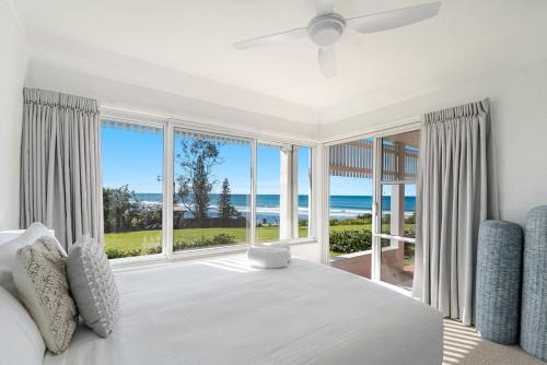 a bedroom with a large bed and large windows at Quarterdeck Unit 2 - Lennox Head in Lennox Head