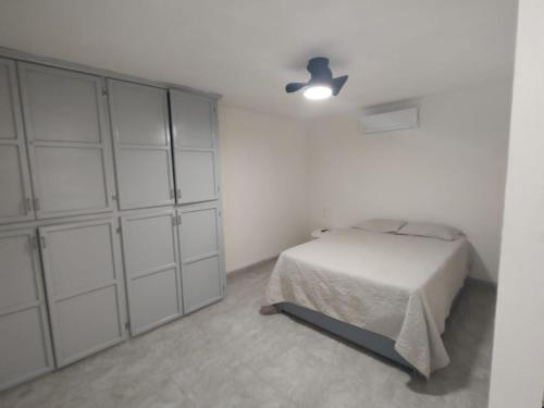 a bedroom with a bed and a large closet at Santafe Suites in Hermosillo