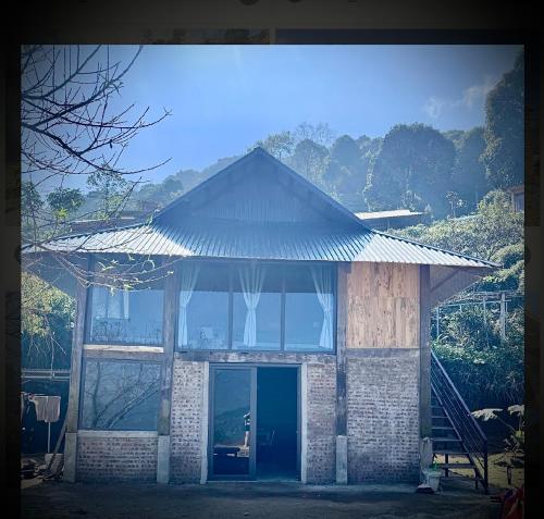 a building with a large window and a door at Homestay26 in Bắc Yên