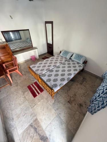 an overhead view of a bedroom with a bed and a mirror at Honeybliss Homestay in Trivandrum