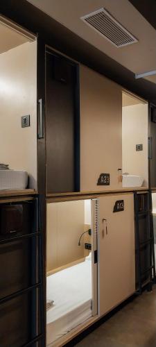 a room with a kitchen with a door open at C2 Pods in Varanasi