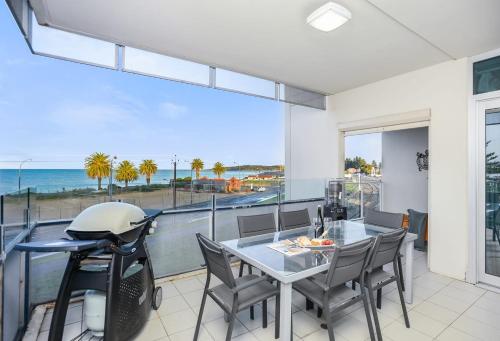 a dining room with a view of the ocean at Frontage Apartments- 3Bedroom Central Seaview Escape in Victor Harbor