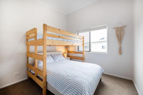 a bedroom with a bunk bed and a window at Conjola Escapes in Green Island