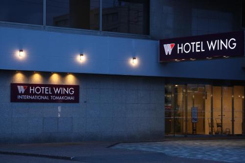 a building with two hotel wings signs on it at Hotel Wing International Tomakomai in Tomakomai