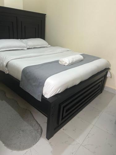 a bed with white sheets and pillows on it at Kamakis spaces in Ruiru