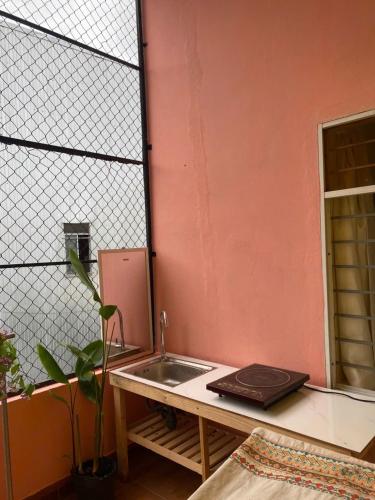 a kitchen with a sink next to a wall at Green home in Da Nang
