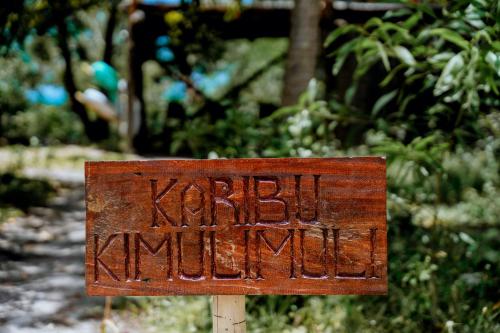 a rusty sign that says kreuziger ambush at Kimulimuli Green Heaven in Kilindoni