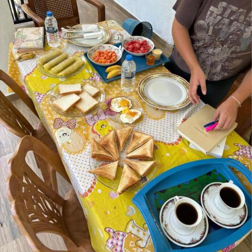a table with breakfast foods and coffee on it at Ella Mist Haven in Ella