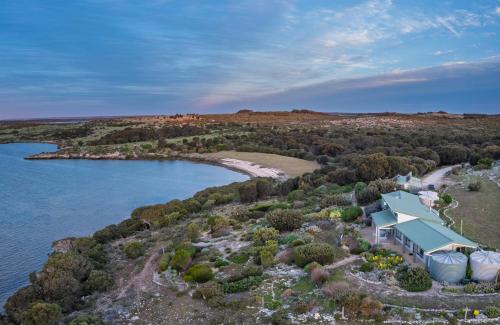 an aerial view of a house on the shore of a lake at Moonrise Cove in Pelican Lagoon
