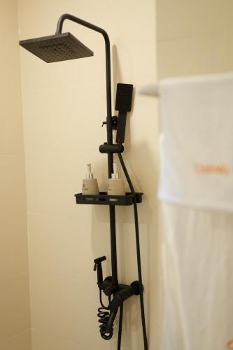 a black lamp sitting on a stand in a room at Chang Chang Cozy Home in Kon Rung (1)