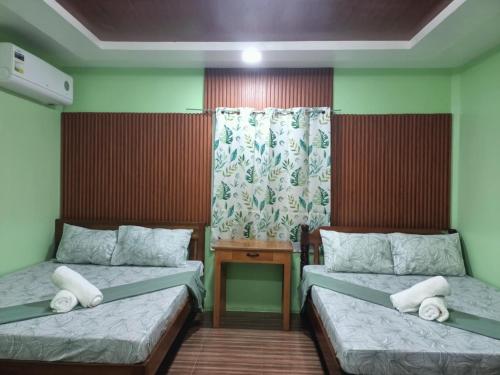 a room with two beds and a window at JANHOUR PLACE in San Vicente